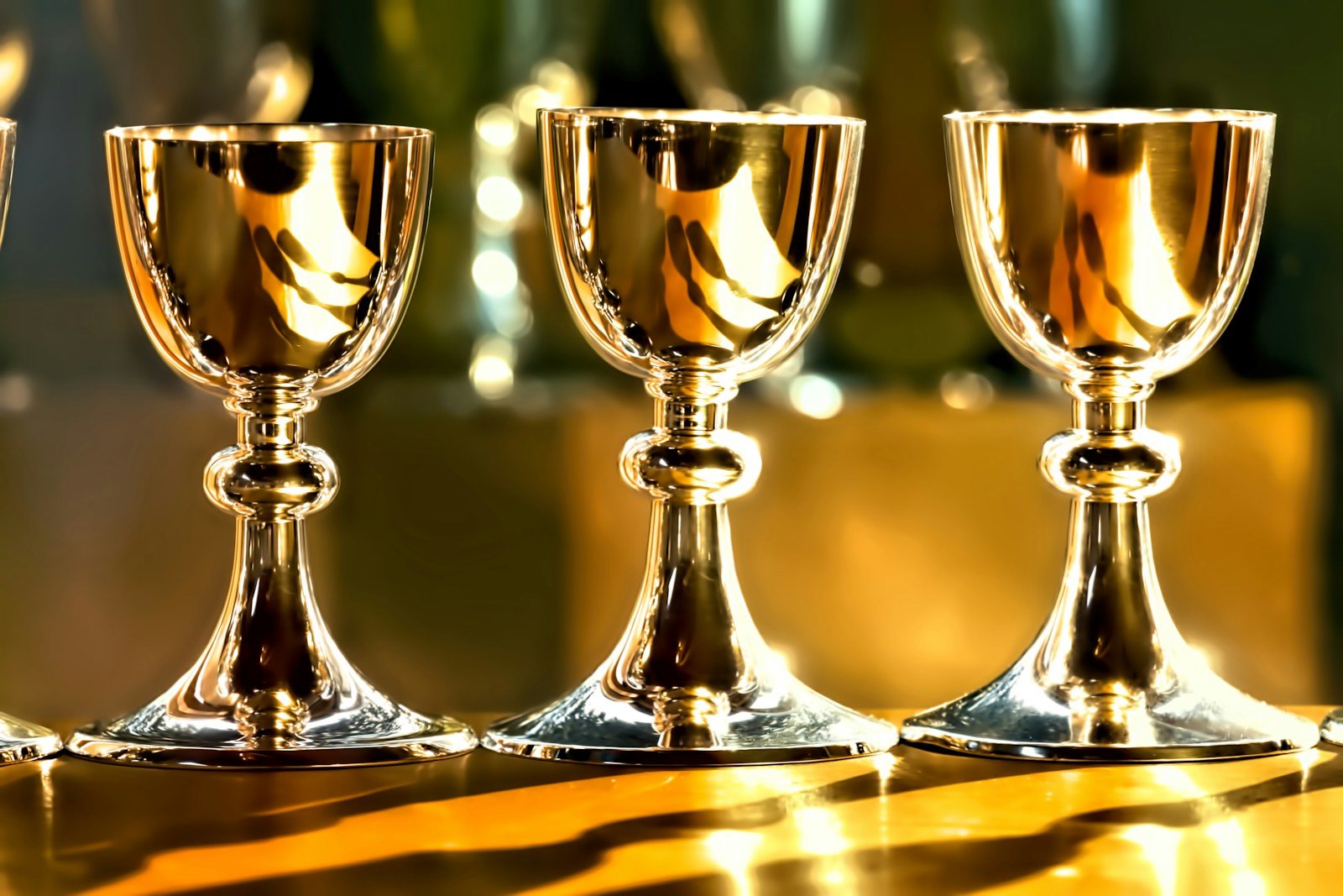 three gold chalice